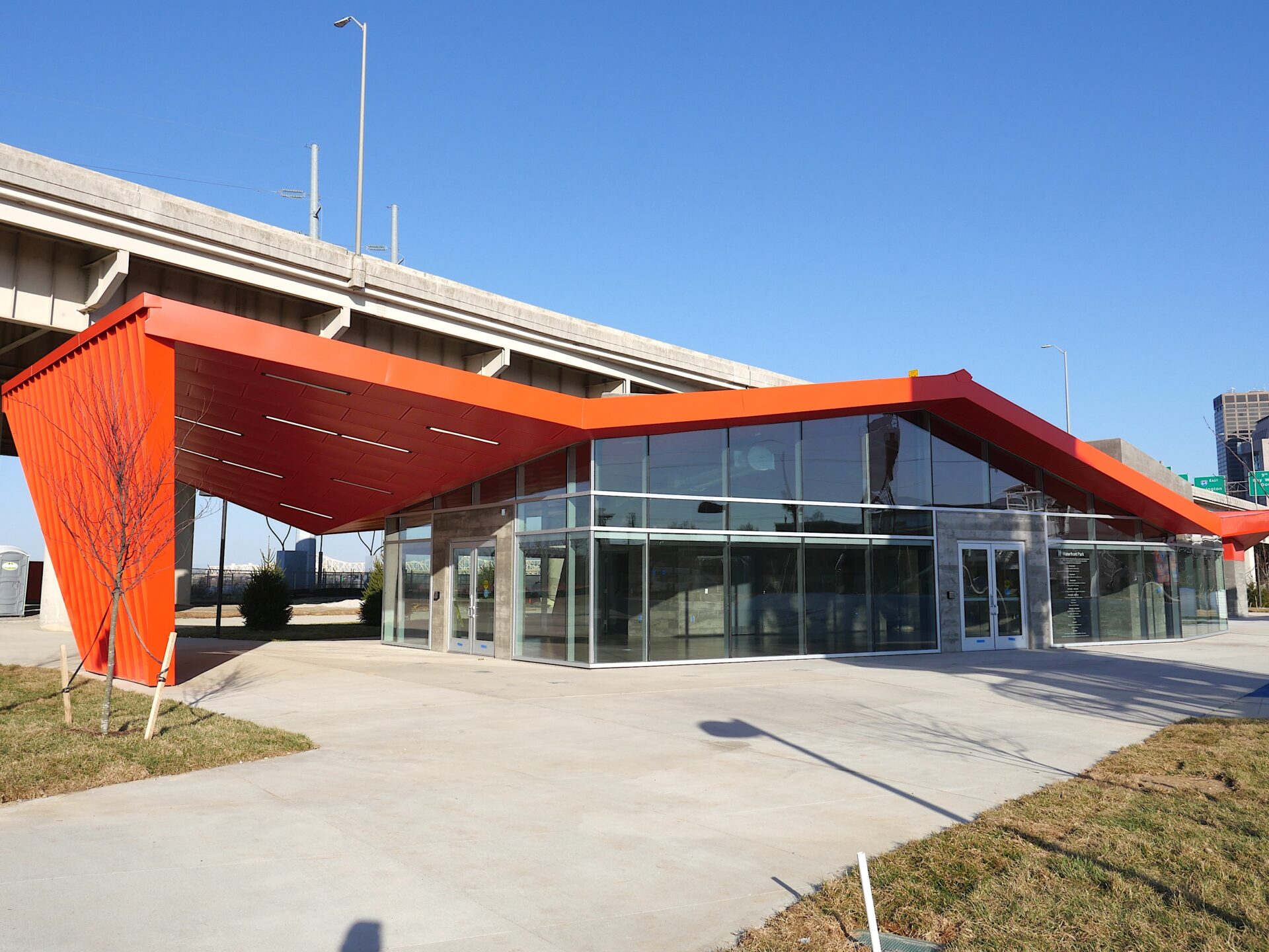 PlayPort event building features an orange roof and floor to ceiling windows with double doors.