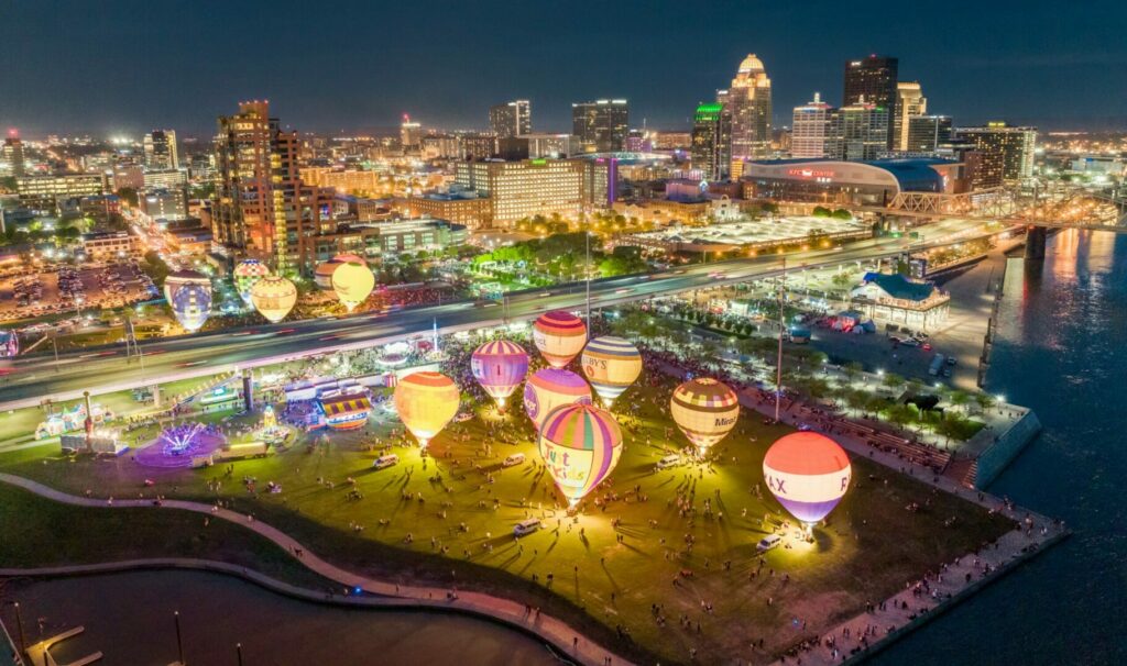 Overlook of Waterfront Park's Great Lawn with a showcase of glowing hot air balloons