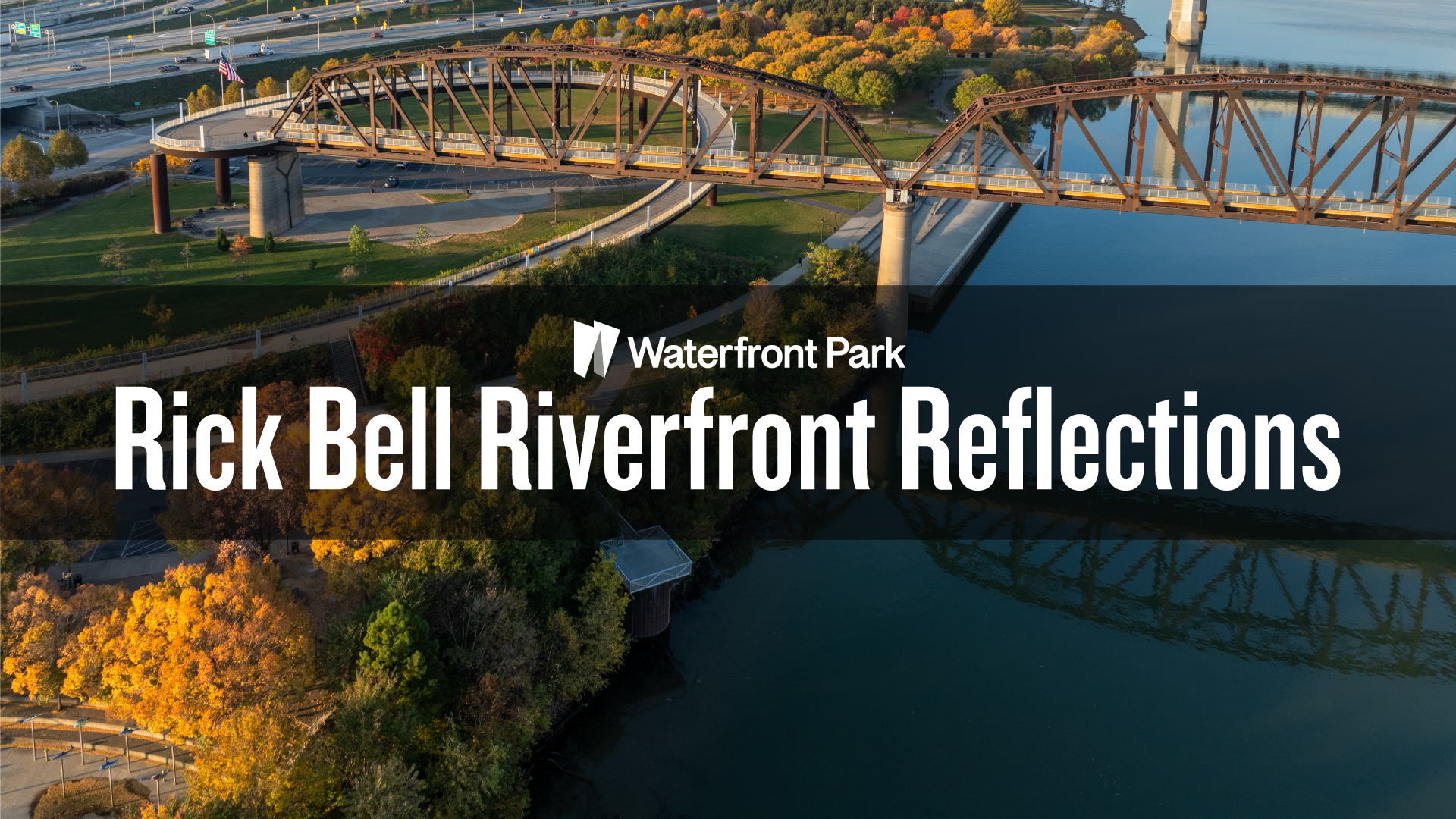 A westward view of Waterfront Park and Ohio River with bridges and city skyline in the background.